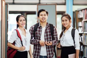 degree in business management 3 students in library